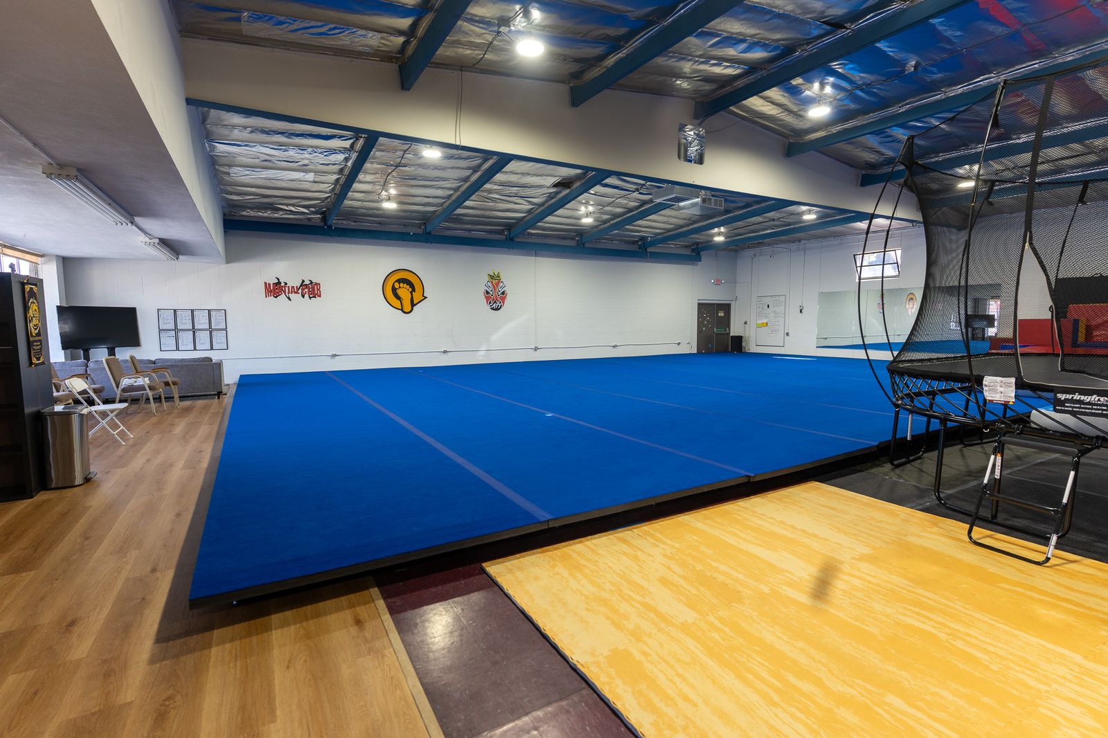 Loopkicks gym floor with blue air track and trampoline